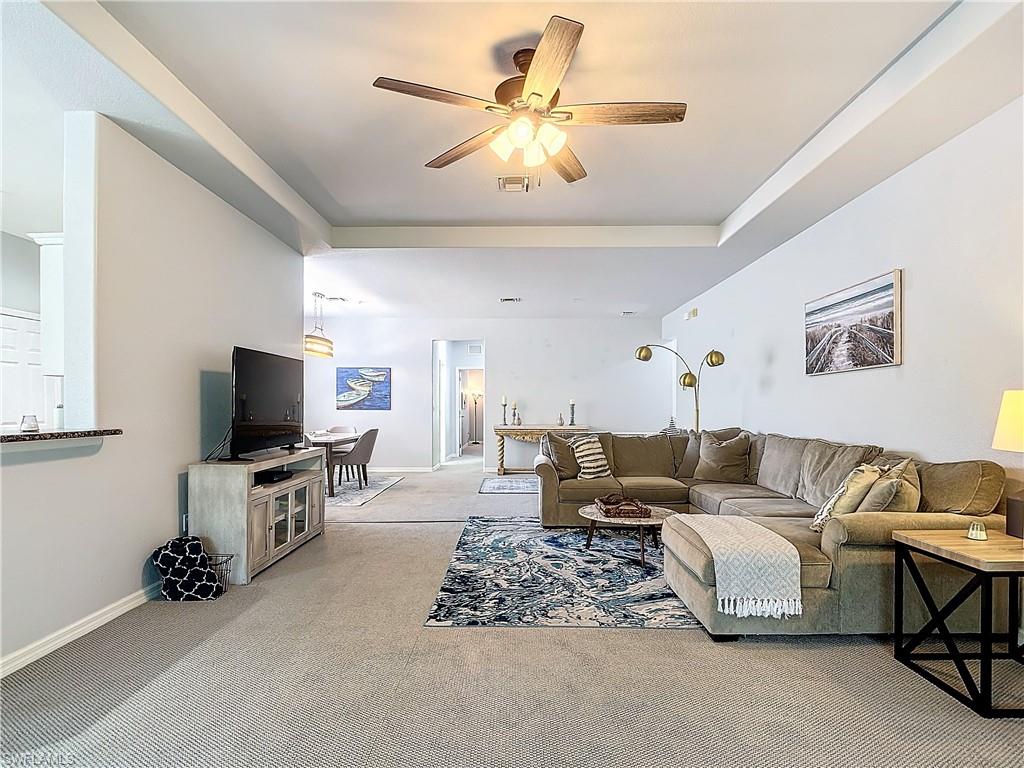 12854 Carrington Circle, Unit 204 Naples, FL 34105 - Photo 8 of 37 a living room with furniture and a flat screen tv