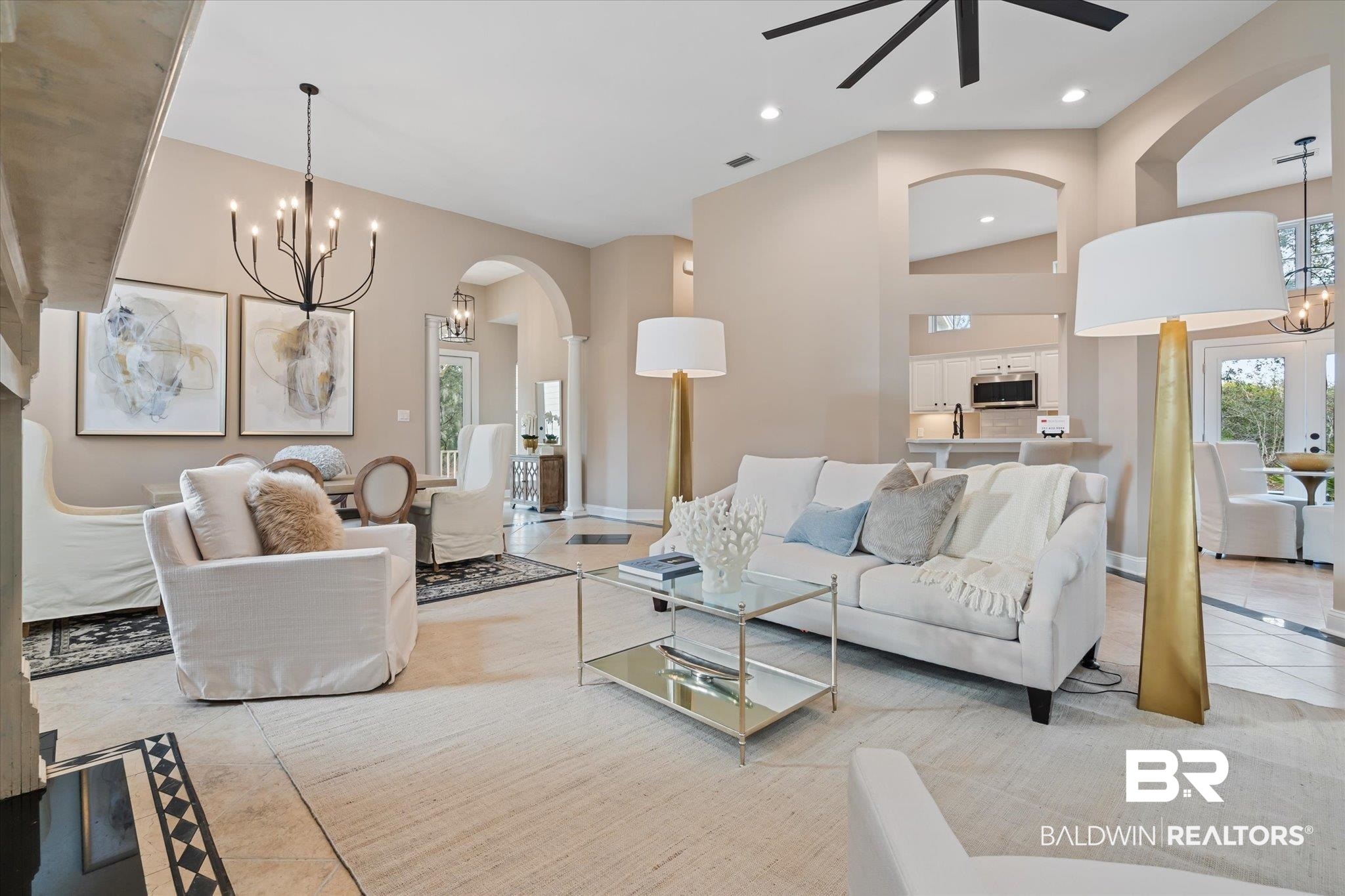 9259 Genipa Way Gulf Shores, AL 36542 - Photo 24 of 72 Tiled living room featuring ceiling fan with notable chandelier