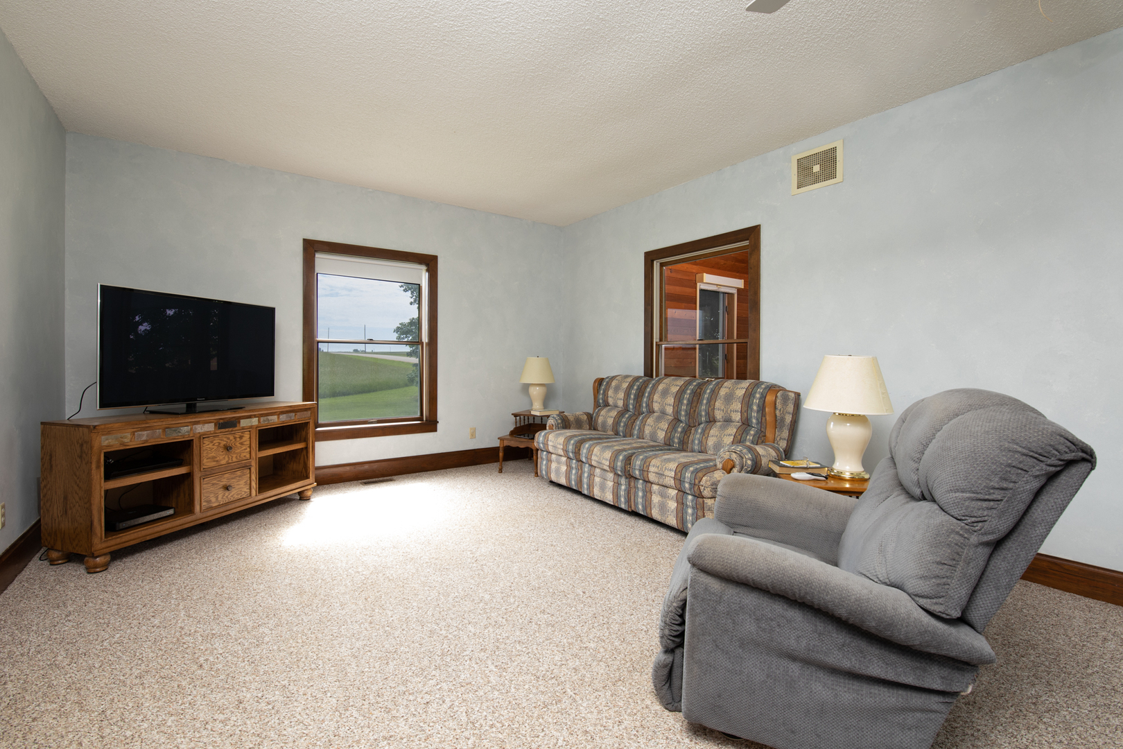 6135 Base Line Road Kirkland, IL 60146 - Photo 36 of 48 a living room with furniture and a flat screen tv