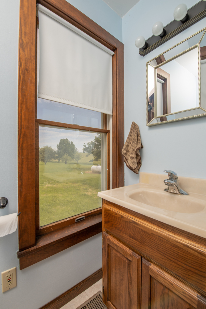 6135 Base Line Road Kirkland, IL 60146 - Photo 40 of 48 a bathroom with a sink and a large mirror