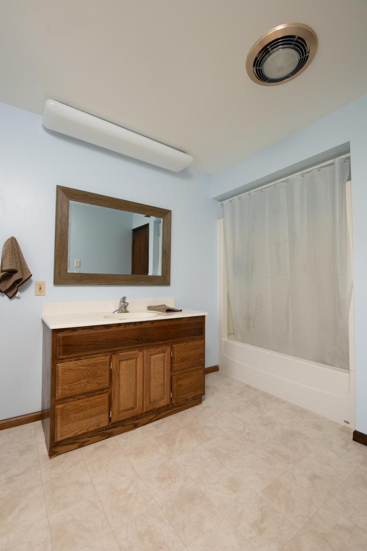 6135 Base Line Road Kirkland, IL 60146 - Photo 43 of 48 a bathroom with a sink a mirror and window