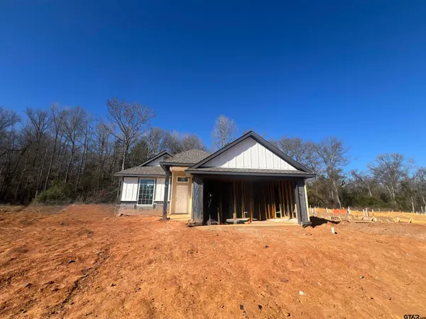 a view of a house with a yard covered in snow