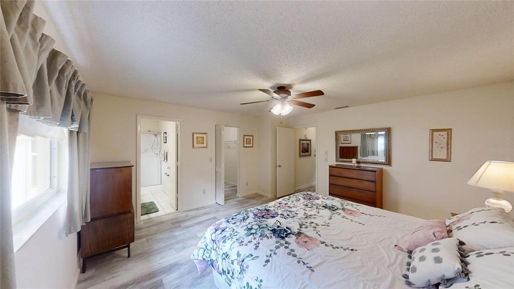 8592 Southwest 91 Street, Unit E Ocala, FL 34481 - Photo 14 of 20 a bedroom with a bed and a dresser