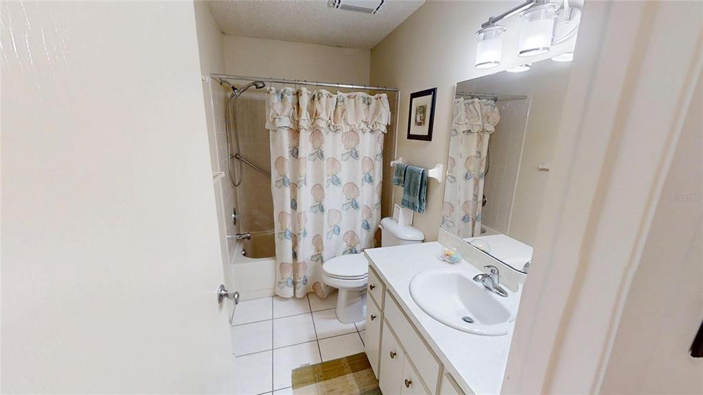 8592 Southwest 91 Street, Unit E Ocala, FL 34481 - Photo 17 of 20 a bathroom with a sink a toilet and shower