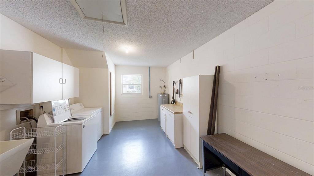 8592 Southwest 91 Street, Unit E Ocala, FL 34481 - Photo 18 of 20 a living room with furniture and a refrigerator