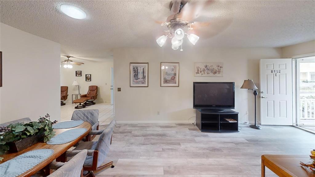 8592 Southwest 91 Street, Unit E Ocala, FL 34481 - Photo 4 of 20 a living room with furniture and a flat screen tv