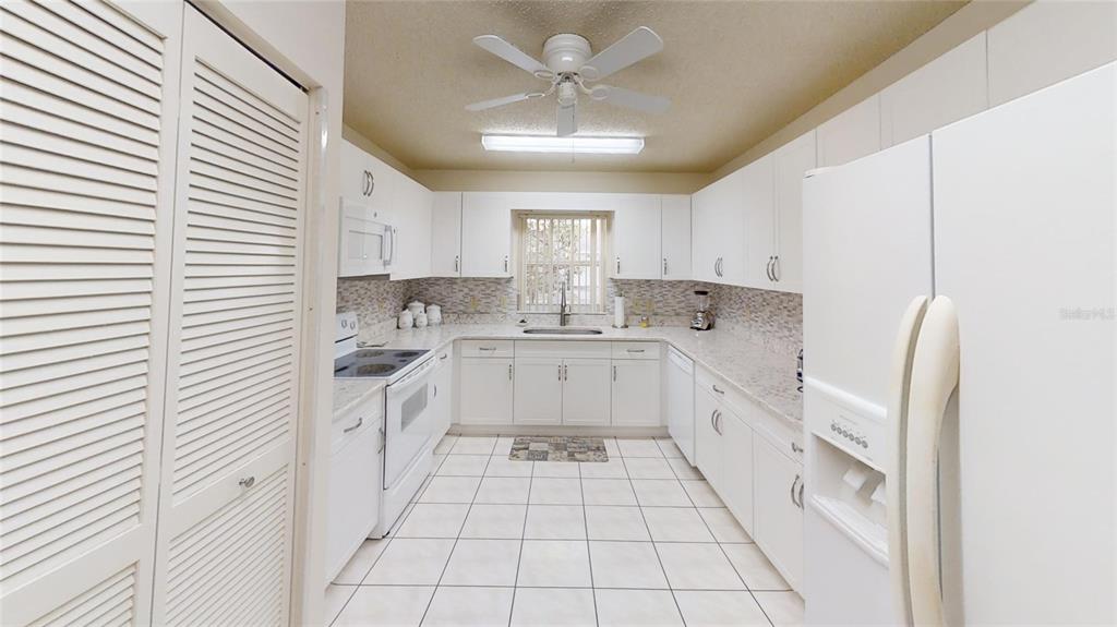 8592 Southwest 91 Street, Unit E Ocala, FL 34481 - Photo 6 of 20 a kitchen with stainless steel appliances cabinets a sink and a window