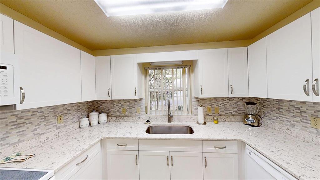 8592 Southwest 91 Street, Unit E Ocala, FL 34481 - Photo 7 of 20 a kitchen with a sink and cabinets