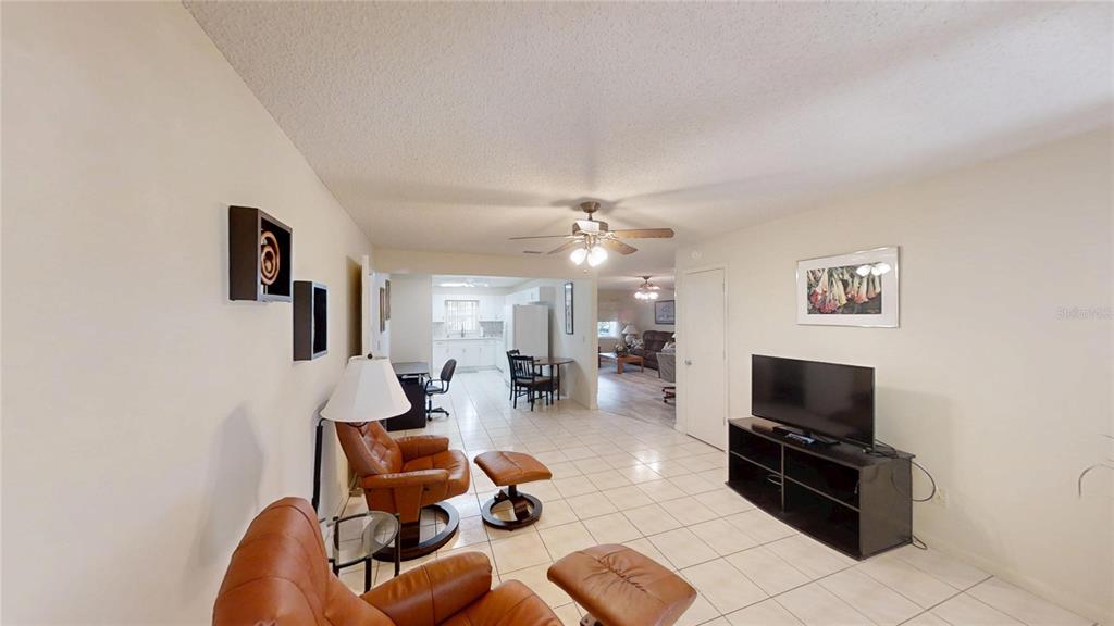 8592 Southwest 91 Street, Unit E Ocala, FL 34481 - Photo 9 of 20 a living room with furniture and a flat screen tv
