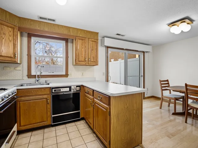 a kitchen with a stove a sink and a refrigerator