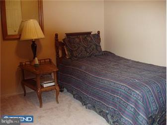 62 Bayberry Road Ewing, NJ 08618 - Photo 11 of 11 a bed sitting in a bedroom next to a lamp
