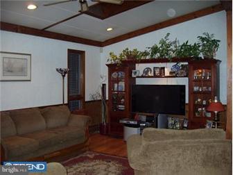62 Bayberry Road Ewing, NJ 08618 - Photo 4 of 11 a living room with furniture a flat screen tv and a fireplace