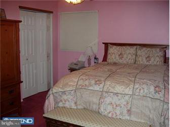 62 Bayberry Road Ewing, NJ 08618 - Photo 8 of 11 a bedroom with a bed and a dresser with wooden floor