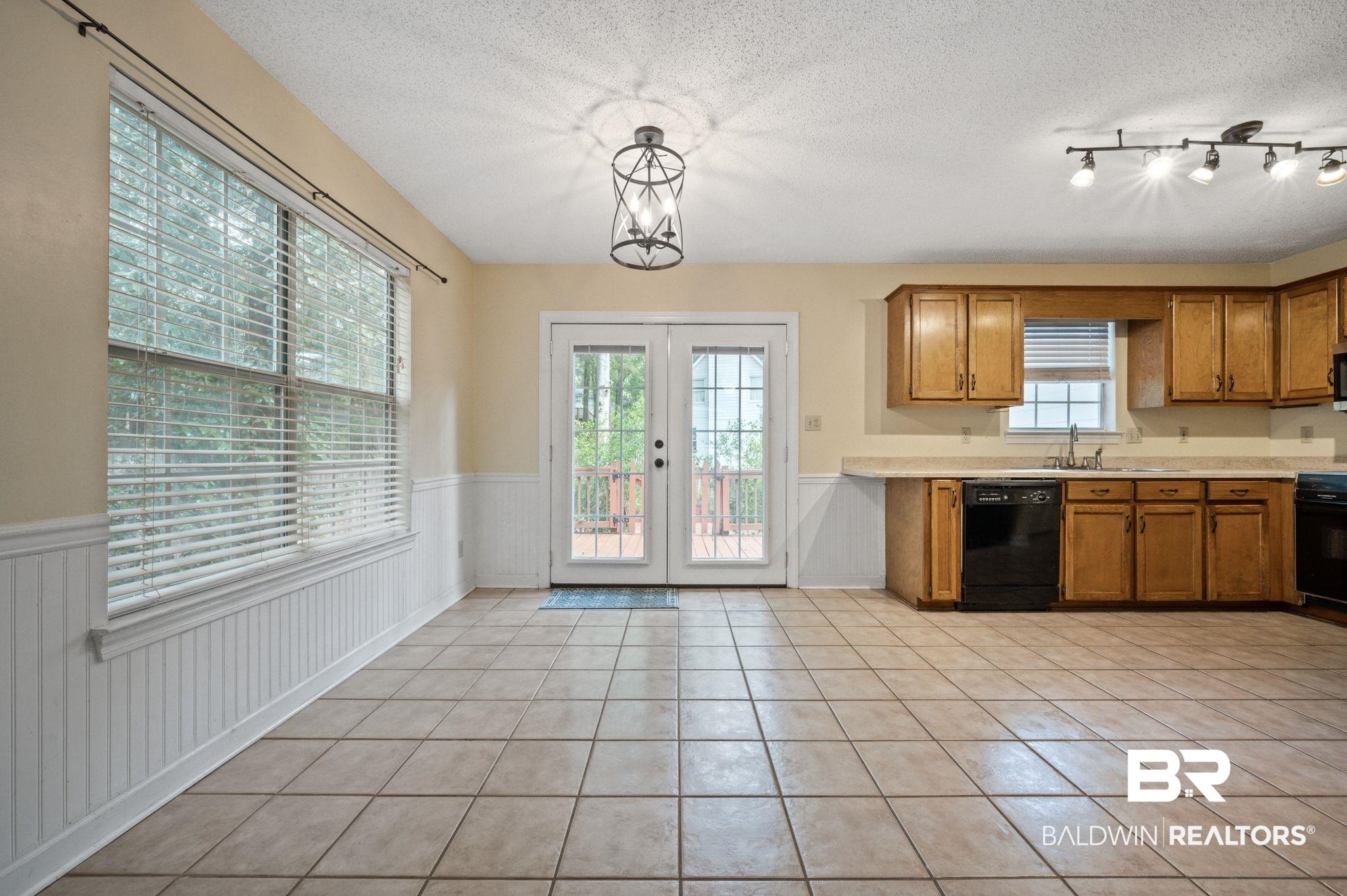 100 Montclair Loop Daphne, AL 36526 - Photo 20 of 39 Kitchen with french doors, a healthy amount of sunlight, black appliances, and pendant lighting