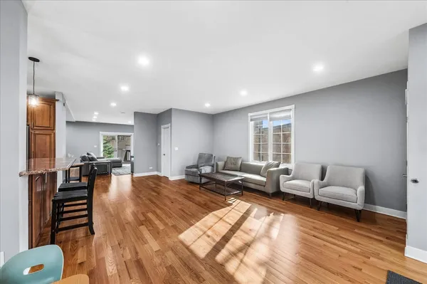 a living room with furniture and a wooden floor