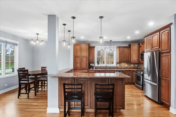 a kitchen with stainless steel appliances granite countertop a refrigerator stove and sink