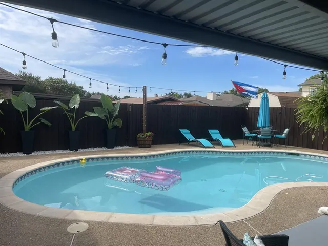 a view of a swimming pool with a yard
