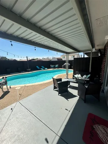 a living room with lots of furniture and a open kitchen