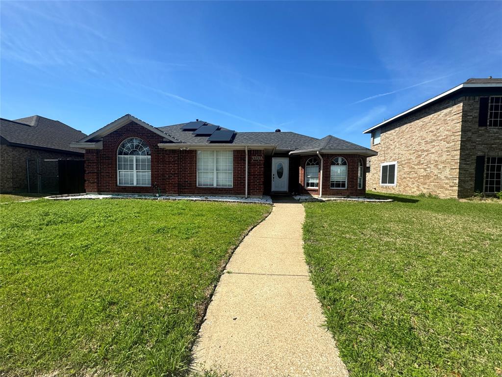 6717 Trumpet Drive Rowlett, TX 75089 - Photo 4 of 12 a front view of a house with a yard and garage