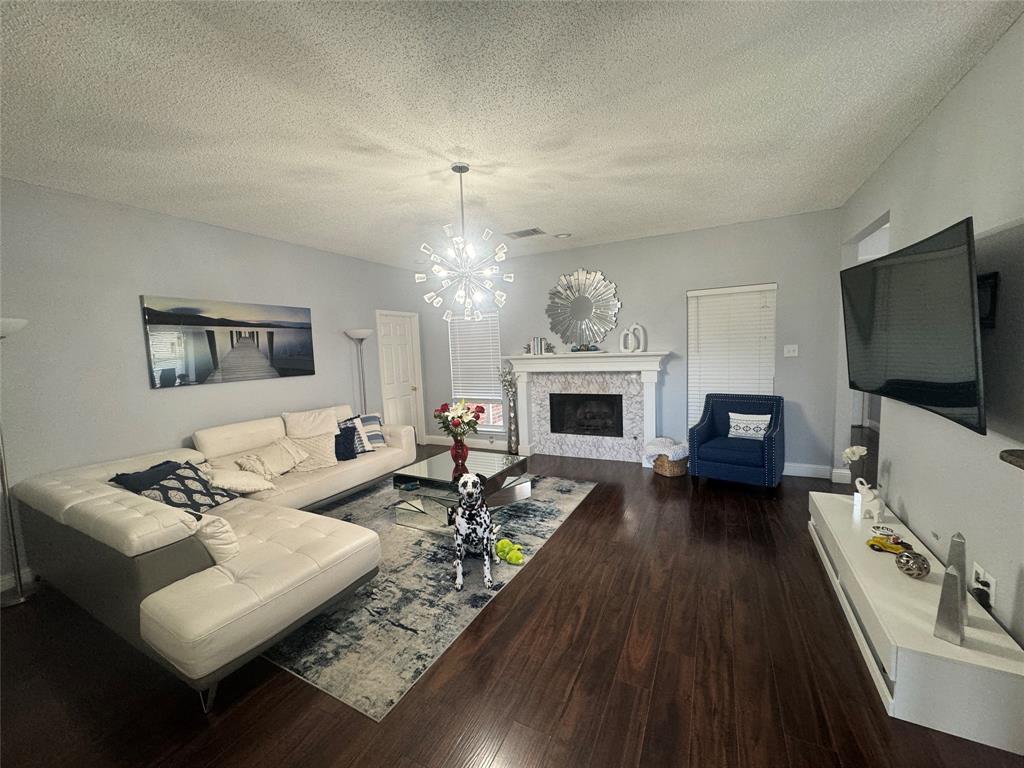 6717 Trumpet Drive Rowlett, TX 75089 - Photo 6 of 12 a living room with furniture fireplace and flat screen tv