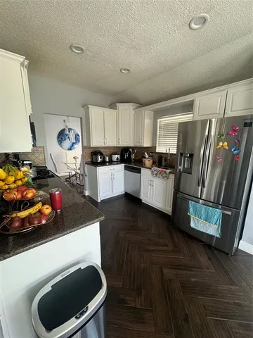 a kitchen with a refrigerator and a stove
