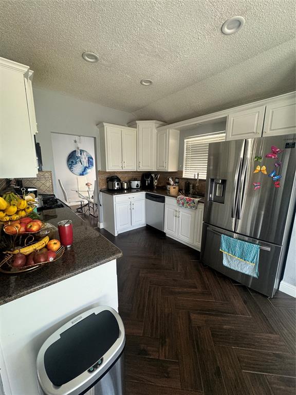 6717 Trumpet Drive Rowlett, TX 75089 - Photo 8 of 12 a kitchen with a refrigerator and a stove