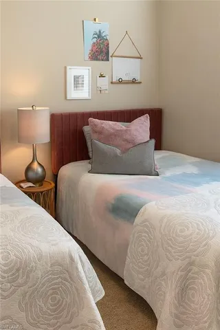 a bedroom with a bed and lamp