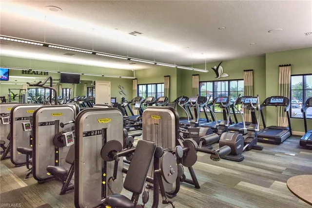 a view of a house with a yard and palm trees
