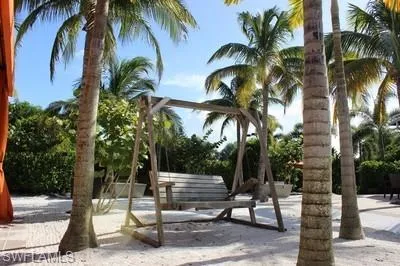 a view of a kitchen with lots of counter and chairs