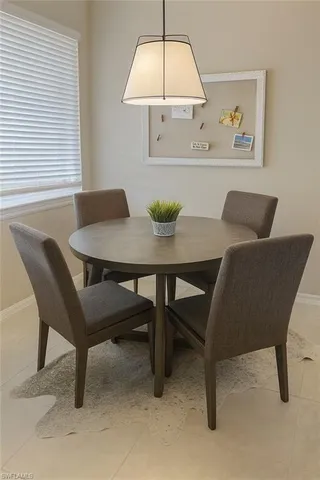 a view of a dining room with furniture and window