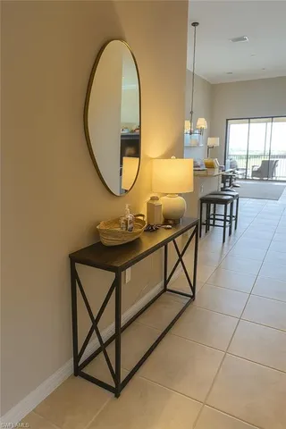 a living room with table and a mirror