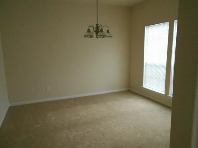 a view of a room with a window and a ceiling fan