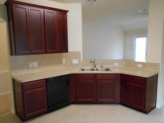 a kitchen with a sink and cabinets