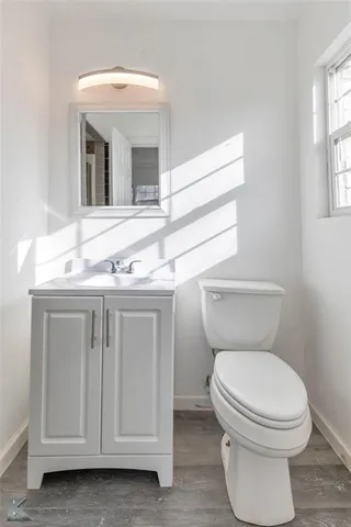 a bathroom with a toilet sink and mirror