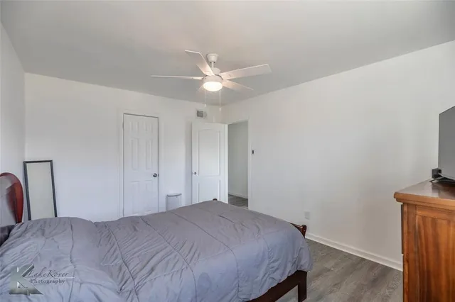 a bedroom with a bed and a ceiling fan