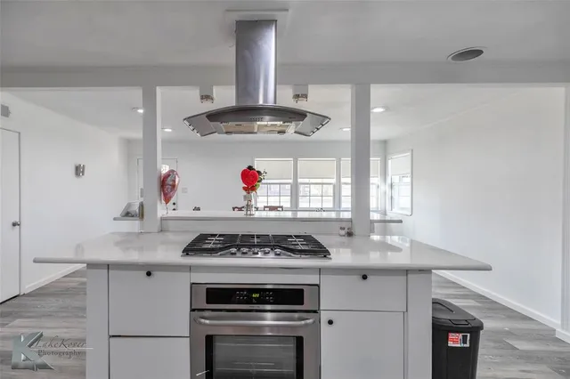 a kitchen with granite countertop a stove and a sink
