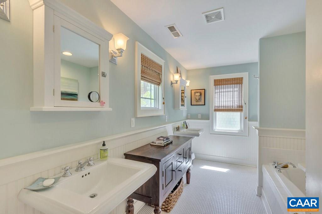 831 Village Road Charlottesville, VA 22903 - Photo 23 of 43 a bathroom with a sink tub and a mirror