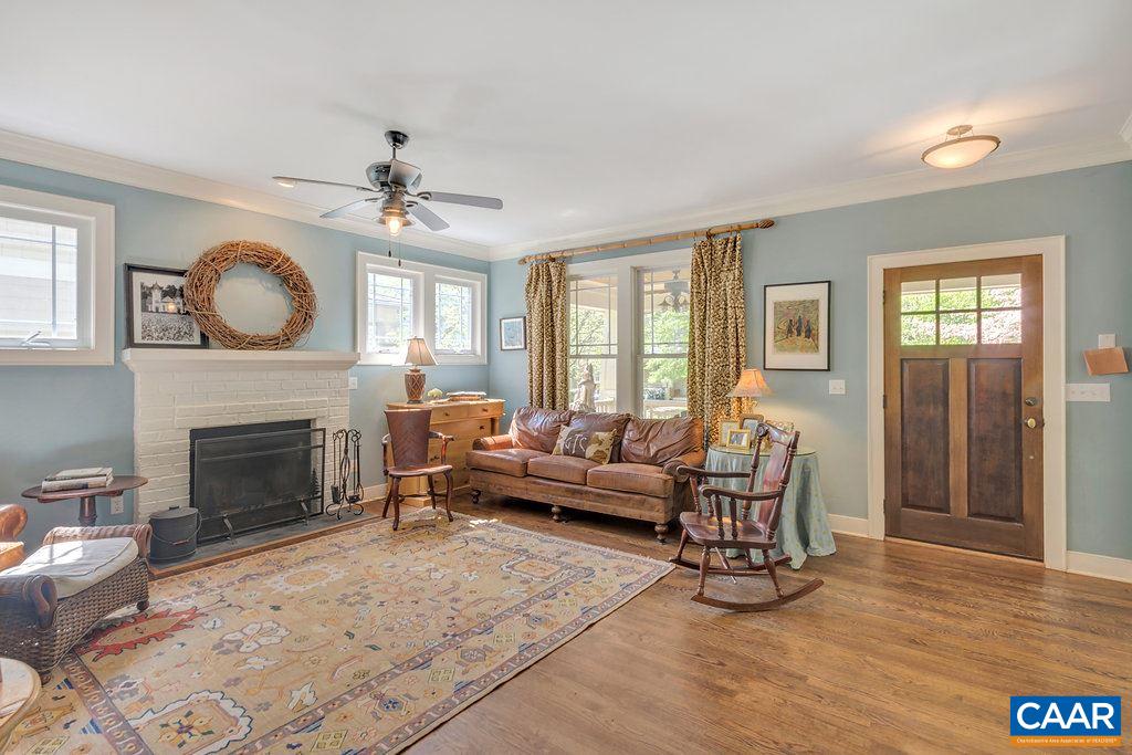 831 Village Road Charlottesville, VA 22903 - Photo 6 of 43 a living room with furniture a fireplace and a large window