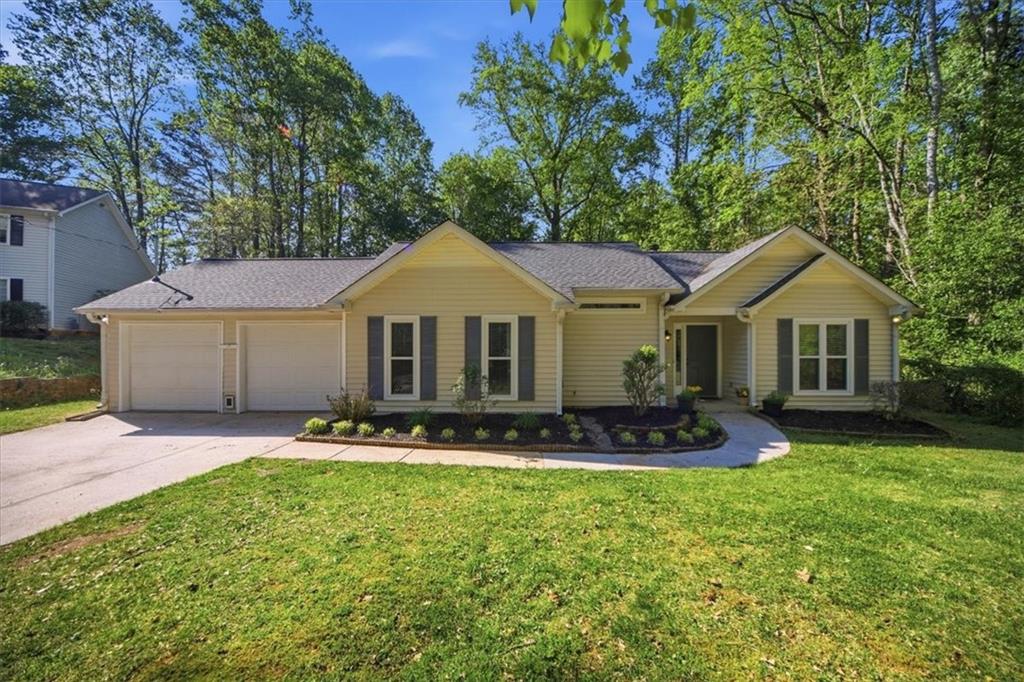 8068 Whitney Court Canton, GA 30115 - Photo 1 of 32 a front view of a house with a yard and garage