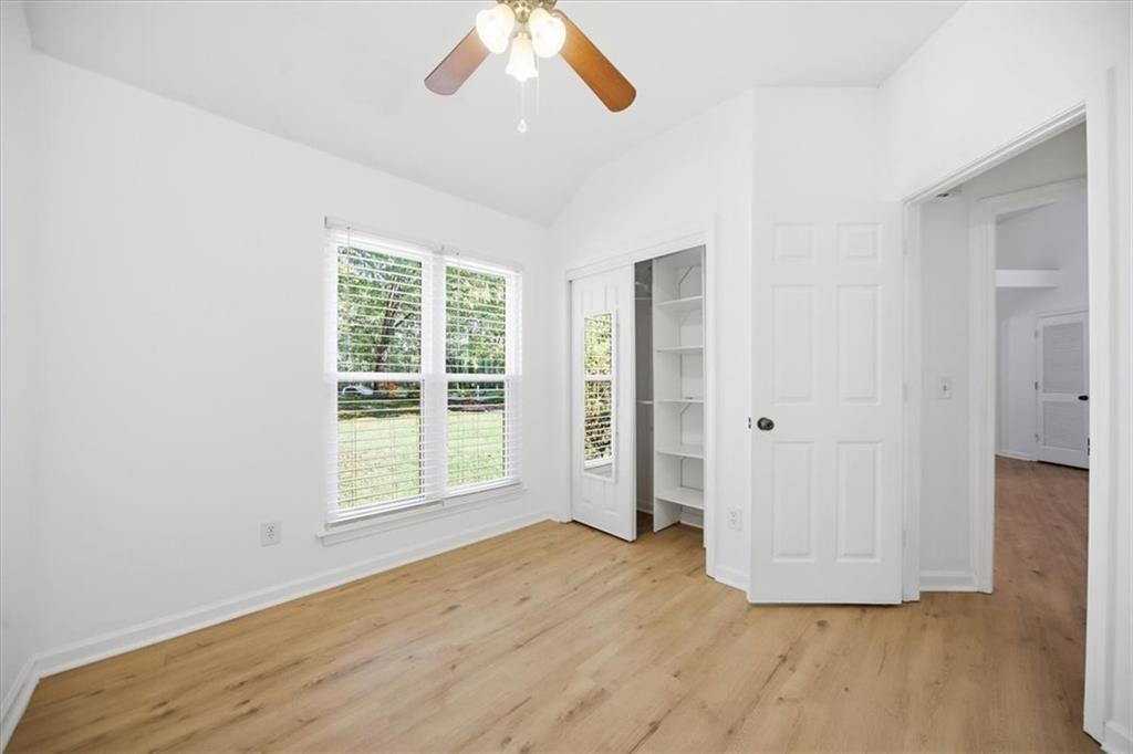 8068 Whitney Court Canton, GA 30115 - Photo 14 of 32 a view of an empty room with wooden floor and a window
