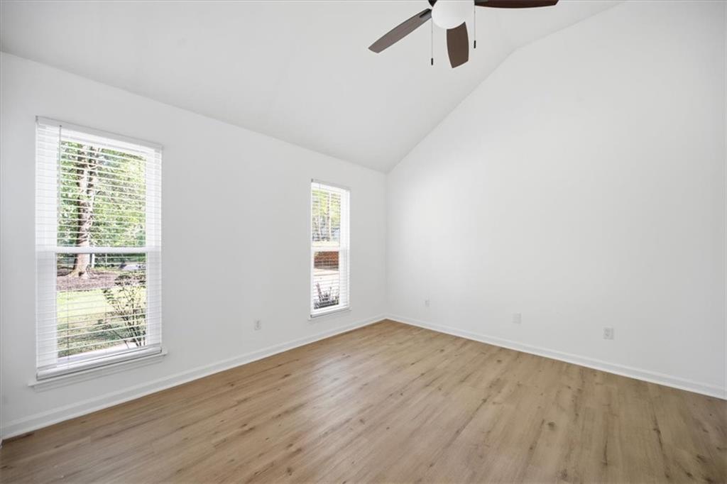 8068 Whitney Court Canton, GA 30115 - Photo 18 of 32 wooden floor in an empty room with a window