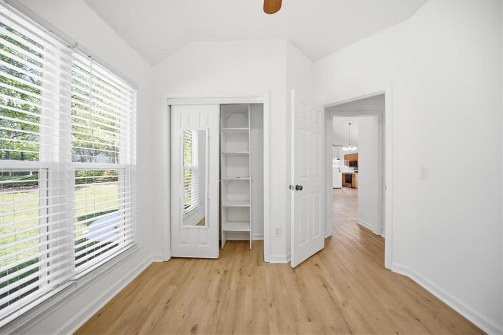 8068 Whitney Court Canton, GA 30115 - Photo 21 of 32 a view of wooden floor and windows in a room