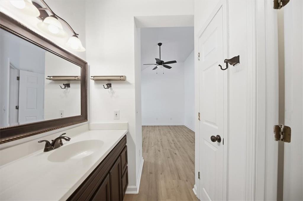 8068 Whitney Court Canton, GA 30115 - Photo 24 of 32 a bathroom with a sink and mirror