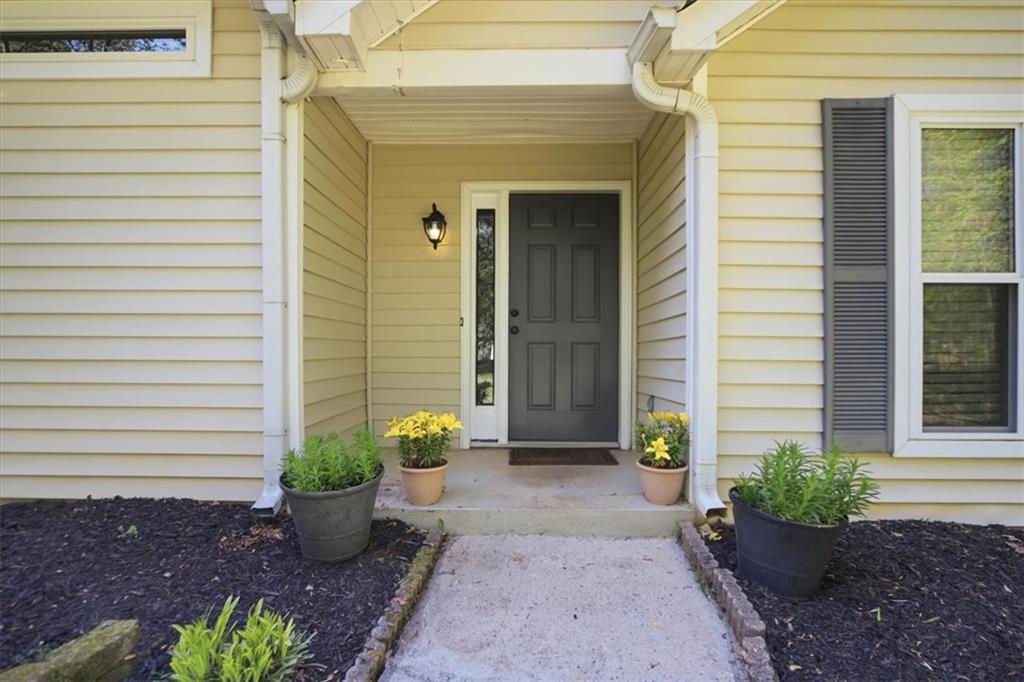 8068 Whitney Court Canton, GA 30115 - Photo 5 of 32 a view of a path with potted plants
