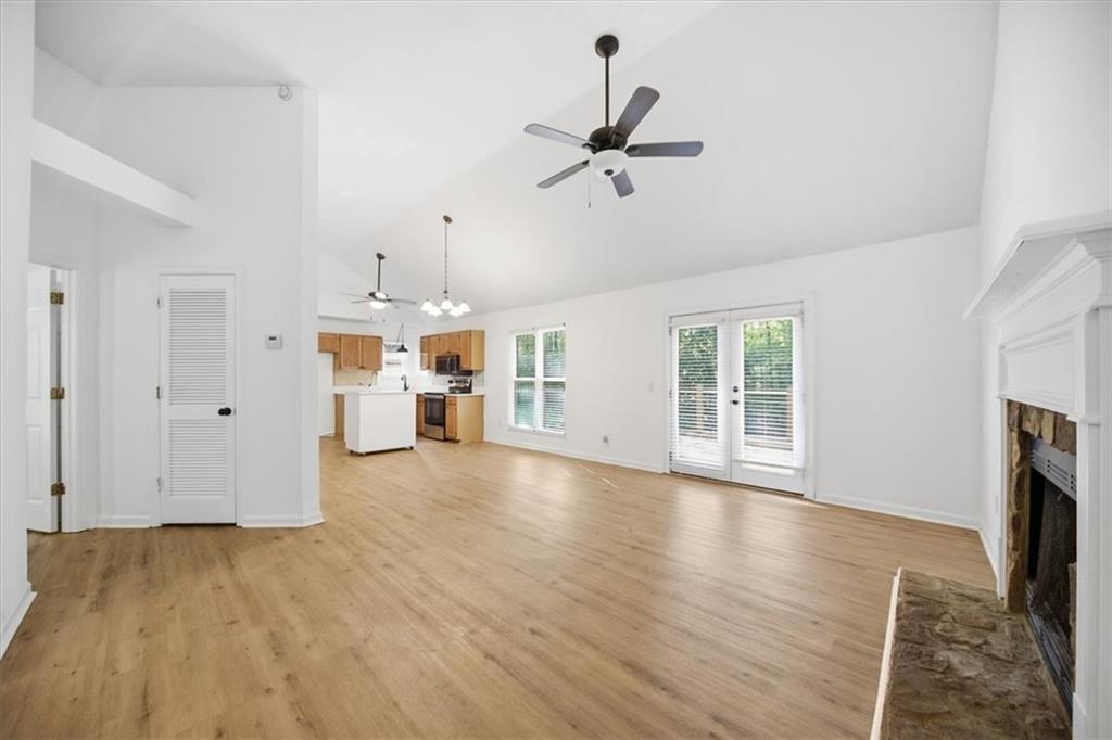 8068 Whitney Court Canton, GA 30115 - Photo 7 of 32 a view of empty room with wooden floor and fireplace