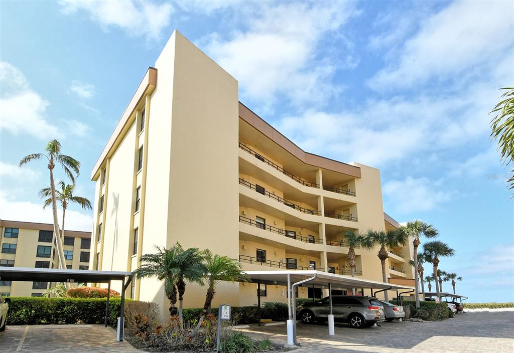 8764 Midnight Pass Road, Unit A306 Sarasota, FL 34242 - Photo 2 of 53 a front view of a building with street view