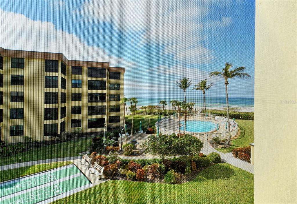 8764 Midnight Pass Road, Unit A306 Sarasota, FL 34242 - Photo 3 of 53 a view of a swimming pool in front of a building