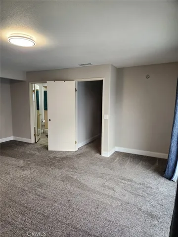 an empty room with a projector and a window