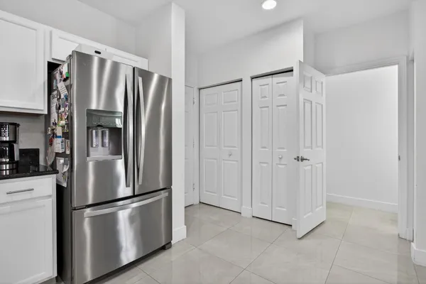 a metallic refrigerator freezer sitting in a kitchen