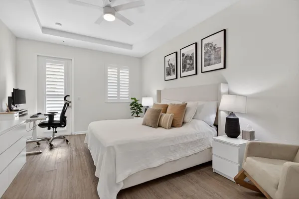a bedroom with a bed a couch and a window